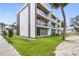 Townhome exterior with a modern design featuring balconies, a well-kept lawn, and newly installed landscaping at 101 W Warren Ave # 1, Tampa, FL 33602