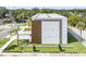 A modern townhome with a white and wood exterior, lush landscaping, and a well-manicured lawn at 101 W Warren Ave # 1, Tampa, FL 33602