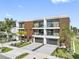 Modern townhome complex featuring private garages, balconies, updated landscaping and brick-paved driveways at 101 W Warren Ave # 1, Tampa, FL 33602