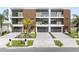 Modern townhome exterior featuring balconies, gray garages, stone driveway, and beautiful tropical landscaping at 101 W Warren Ave # 1, Tampa, FL 33602
