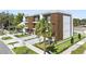 Modern townhome showcasing balconies, gray garages, and a beautifully landscaped front yard for curb appeal at 101 W Warren Ave # 1, Tampa, FL 33602