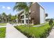 Modern townhome boasts balconies, gray garages, and is adorned with meticulously landscaped front yard at 101 W Warren Ave # 1, Tampa, FL 33602