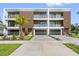 View of townhomes boasting private balconies and attached garages, framed by lush greenery and a clear blue sky at 101 W Warren Ave # 1, Tampa, FL 33602