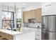 Modern kitchen features stainless appliances, quartz countertops, and a view of the neighborhood at 101 W Warren Ave # 1, Tampa, FL 33602