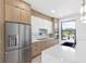 Modern kitchen featuring stainless steel appliances, light wood cabinets, and a large island at 101 W Warren Ave # 1, Tampa, FL 33602