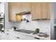 Gourmet kitchen features modern appliances, quartz countertops, and a pot filler over the cooktop at 101 W Warren Ave # 1, Tampa, FL 33602