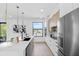 Contemporary kitchen boasts stainless appliances, quartz countertops, pendant lights, and ample counter space at 101 W Warren Ave # 1, Tampa, FL 33602