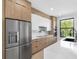 Modern kitchen featuring stainless steel appliances, contrasting wood and white cabinetry, and bright natural light at 101 W Warren Ave # 1, Tampa, FL 33602