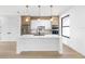 Modern kitchen featuring a large island, stainless steel appliances, and stylish pendant lighting at 101 W Warren Ave # 1, Tampa, FL 33602