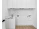 Clean laundry room with white cabinetry, modern fixtures, and ample storage space at 101 W Warren Ave # 1, Tampa, FL 33602