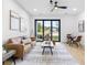 Bright living room with contemporary furnishings, hardwood floors, and natural light from sliding glass doors at 101 W Warren Ave # 1, Tampa, FL 33602
