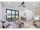Open-concept living room features contemporary furnishings, stylish decor, and large windows that flood the space with light at 101 W Warren Ave # 1, Tampa, FL 33602