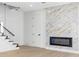 Modern living room with beautiful marble accent wall and fireplace at 101 W Warren Ave # 1, Tampa, FL 33602