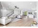 Spacious living room featuring modern decor, an open staircase, and seamless access to the kitchen at 101 W Warren Ave # 1, Tampa, FL 33602