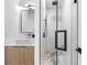 Modern bathroom featuring a glass enclosed shower with black hardware and chevron tile at 101 W Warren Ave # 1, Tampa, FL 33602