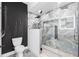 Contemporary shower with blue marble tile, black hardware, glass enclosure, and rainfall shower head at 101 W Warren Ave # 1, Tampa, FL 33602