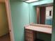 Dressing area with a built-in desk and storage located next to the bathroom and bedroom at 10711 95Th St, Seminole, FL 33777