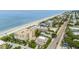 Aerial view showcases property's proximity to sandy beach and blue ocean waters at 11722 Currie Ln # G1, Largo, FL 33774