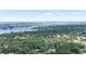 Stunning aerial view showcases water, lush greenery, and Clearwater's skyline in the distance at 11722 Currie Ln # G1, Largo, FL 33774