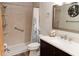 Bathroom showcasing a walk-in shower, modern vanity with sink, and stylish mirror with shells at 11722 Currie Ln # G1, Largo, FL 33774