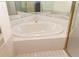 Bathroom features a large soaking tub and a big mirror, perfect for relaxation and grooming at 11722 Currie Ln # G1, Largo, FL 33774