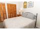 Bedroom featuring a comfortable bed and a big closet, perfect for a restful and organized retreat at 11722 Currie Ln # G1, Largo, FL 33774