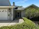 Exterior shot of home with well-maintained lawn and established landscaping at 11722 Currie Ln # G1, Largo, FL 33774