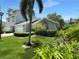 Charming two-story home featuring a well-manicured lawn with beautiful landscaping and a lush green yard at 11722 Currie Ln # G1, Largo, FL 33774