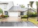 Charming one-story home featuring a garage, well-maintained lawn and mature landscaping at 11722 Currie Ln # G1, Largo, FL 33774