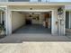 View of the spacious garage with storage shelving, washer, and dryer hookups at 11722 Currie Ln # G1, Largo, FL 33774