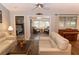 Open living room with French doors leading to sunroom at 11722 Currie Ln # G1, Largo, FL 33774