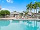 Relaxing pool area featuring comfortable lounge chairs and inviting tropical landscaping at 11722 Currie Ln # G1, Largo, FL 33774