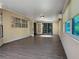 Bright sunroom with tile floors, surrounded by windows offering lush outdoor views at 11722 Currie Ln # G1, Largo, FL 33774