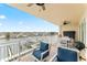 Relaxing balcony view with comfortable seating overlooking the serene waterfront and city skyline at 125 Island Way # 402, Clearwater Beach, FL 33767