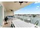 Relaxing balcony with outdoor furniture and serene water views at 125 Island Way # 402, Clearwater Beach, FL 33767