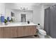 Bathroom boasts a floating vanity, a shower with a gray curtain, and bright lighting at 125 Island Way # 402, Clearwater Beach, FL 33767