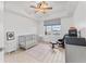 Bedroom with a gray crib, chair, side table, and a window with city views at 125 Island Way # 402, Clearwater Beach, FL 33767