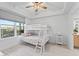 Cozy bedroom with a bunk bed, a large window, and a serene atmosphere, perfect for restful nights at 125 Island Way # 402, Clearwater Beach, FL 33767