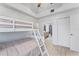 Comfortable bedroom with bunk beds, ceiling fan, and adjacent bathroom at 125 Island Way # 402, Clearwater Beach, FL 33767