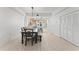 Bright dining area featuring an industrial style chandelier and an open view to the kitchen at 125 Island Way # 402, Clearwater Beach, FL 33767