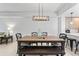 Inviting dining area featuring a wooden table with bench seating and modern light fixture at 125 Island Way # 402, Clearwater Beach, FL 33767