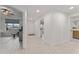Hallway with an open floorplan view of the living room, front door, and a view to the washroom at 125 Island Way # 402, Clearwater Beach, FL 33767