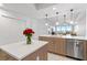 Kitchen with a large island, stainless steel appliances and wooden cabinets at 125 Island Way # 402, Clearwater Beach, FL 33767