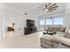 Cozy living room with comfortable sectional, large TV, and access to a scenic balcony at 125 Island Way # 402, Clearwater Beach, FL 33767