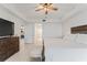 Airy main bedroom boasting ample natural light, a ceiling fan, and seamless access to other rooms at 125 Island Way # 402, Clearwater Beach, FL 33767