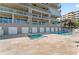 Stunning condominium featuring a shared pool, jacuzzi, sunbathing area, and stunning waterfront views at 125 Island Way # 402, Clearwater Beach, FL 33767