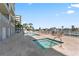 Luxury condominium featuring a sparkling pool, jacuzzi, and lounging area for relaxation and enjoyment at 125 Island Way # 402, Clearwater Beach, FL 33767