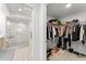Spacious walk-in closet with organization system and direct access to the modern walk-in shower at 125 Island Way # 402, Clearwater Beach, FL 33767