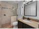 Bathroom featuring a stone shower and a vanity with granite countertop at 12956 Royal George Ave, Odessa, FL 33556