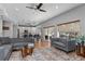Open-concept living room featuring modern furnishings, hardwood floors, and seamless access to the kitchen at 12956 Royal George Ave, Odessa, FL 33556